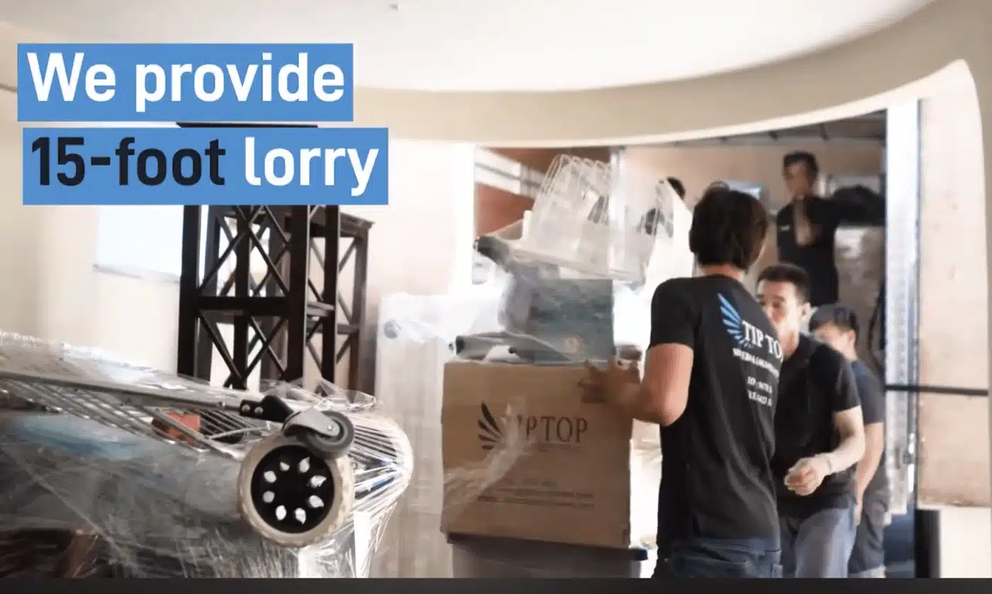 Tip Top Movers Singapore real moving crew loading wrapped items into a 15ft lorry